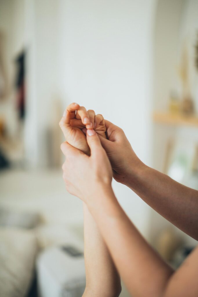Close-up of hands giving a soothing massage, promoting relaxation and wellness indoors.